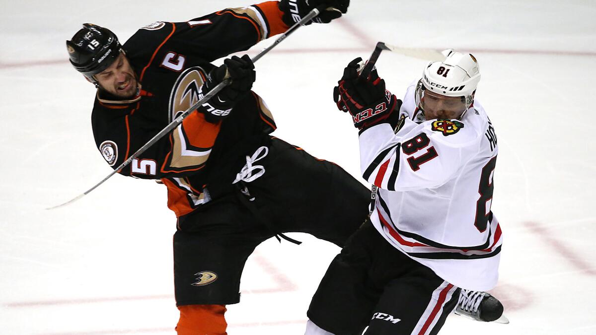 Ducks captain Ryan Getzlaf, left, collides with Chicago Blackhawks forward Marian Hossa during the Ducks' victory in Game 1 of the Western Conference finals in May.