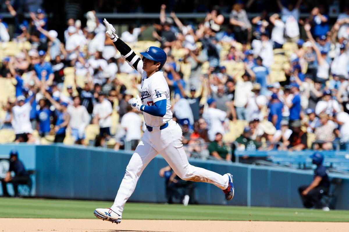 Shohei Ohtani rounds the bases after hitting a solo homer in the eighth inning to extend  the Dodgers' lead to 6-4.