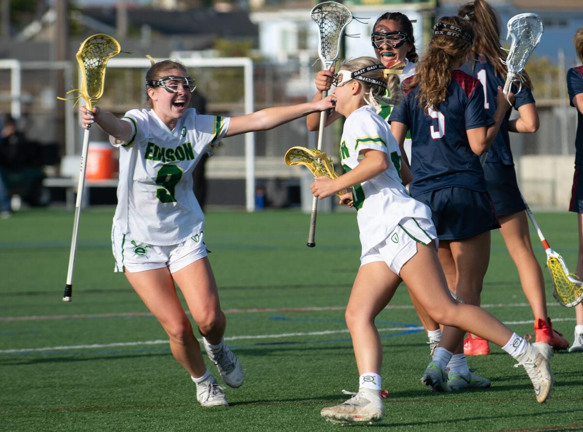 Edison's Haylie Scrimgeour reaches out to congratulate teammate Lauren Salem after she scored a goal during Thursday's match.