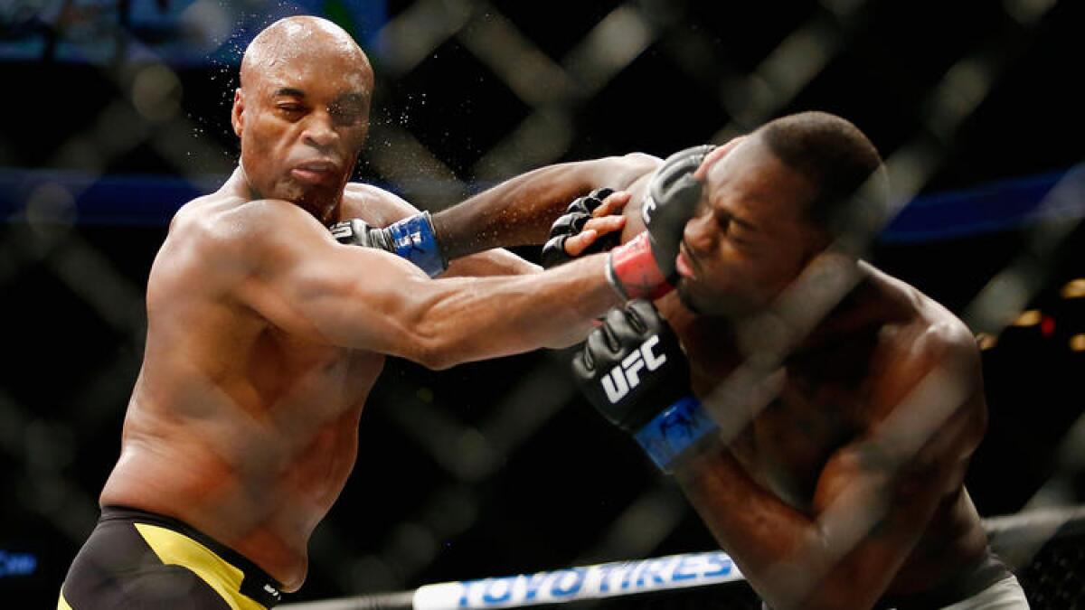 Anderson Silva, left, and Derek Brunson trade punches during their middleweight bout at UFC 208.