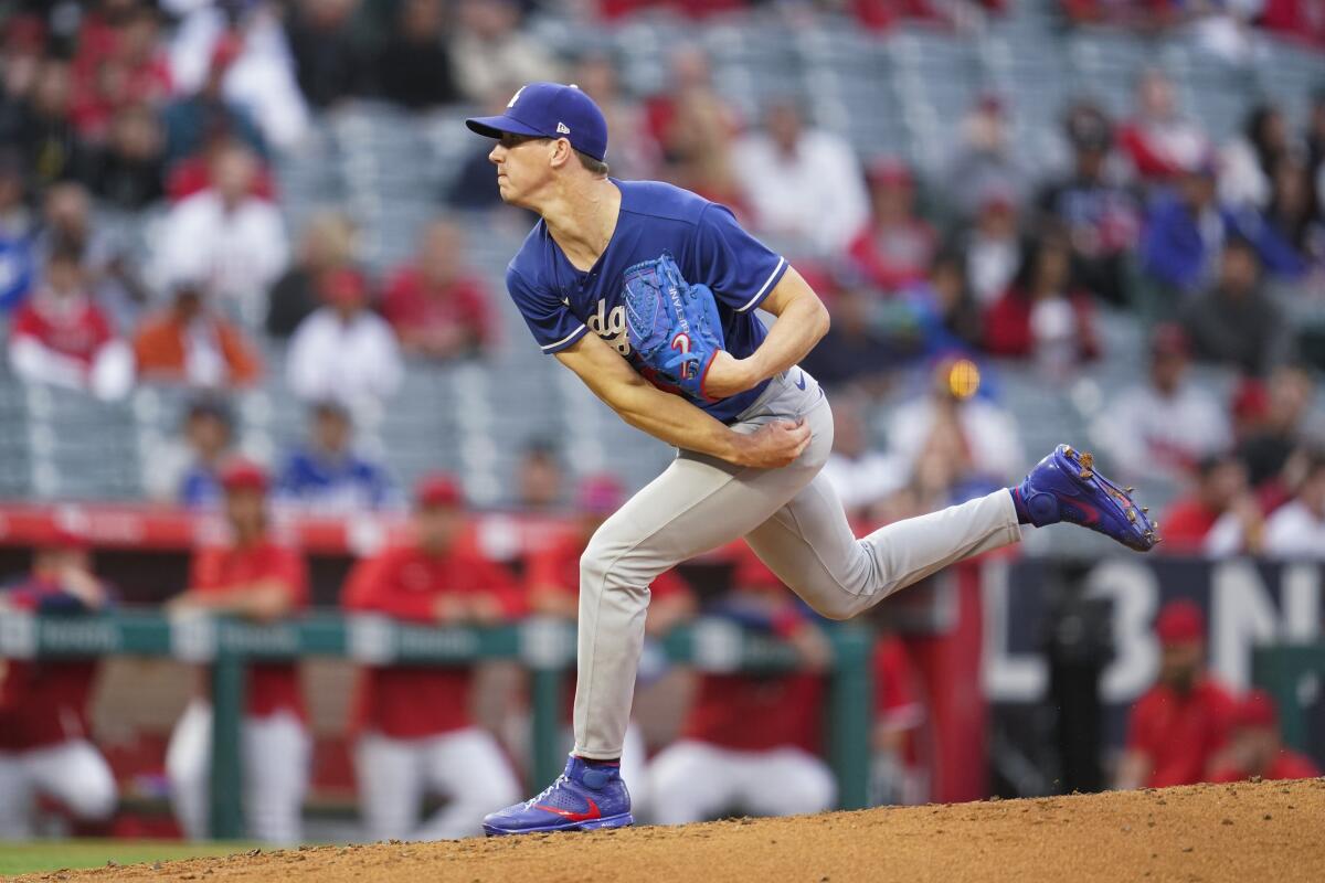 Los Angeles Dodgers starting pitcher Walker Buehler (21) throws during a spring training baseball game.
