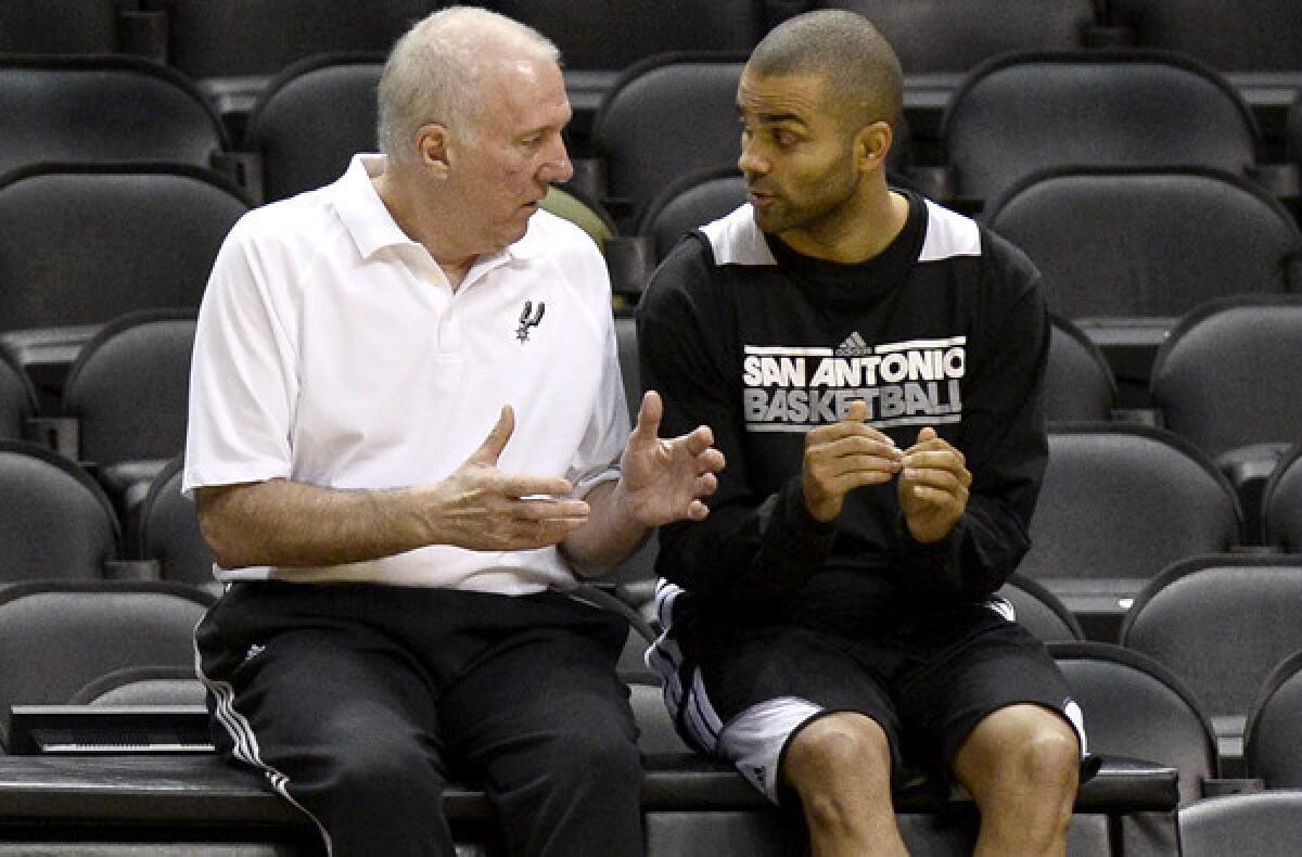 Spurs Coach Gregg Popovich talks with point guard Tony Parker during practice.