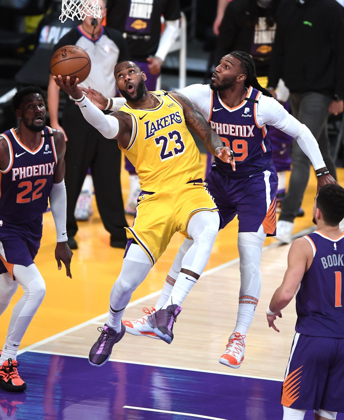 Lakers forward LeBron James scores on a reverse layup against Suns forward Jae Crowder.