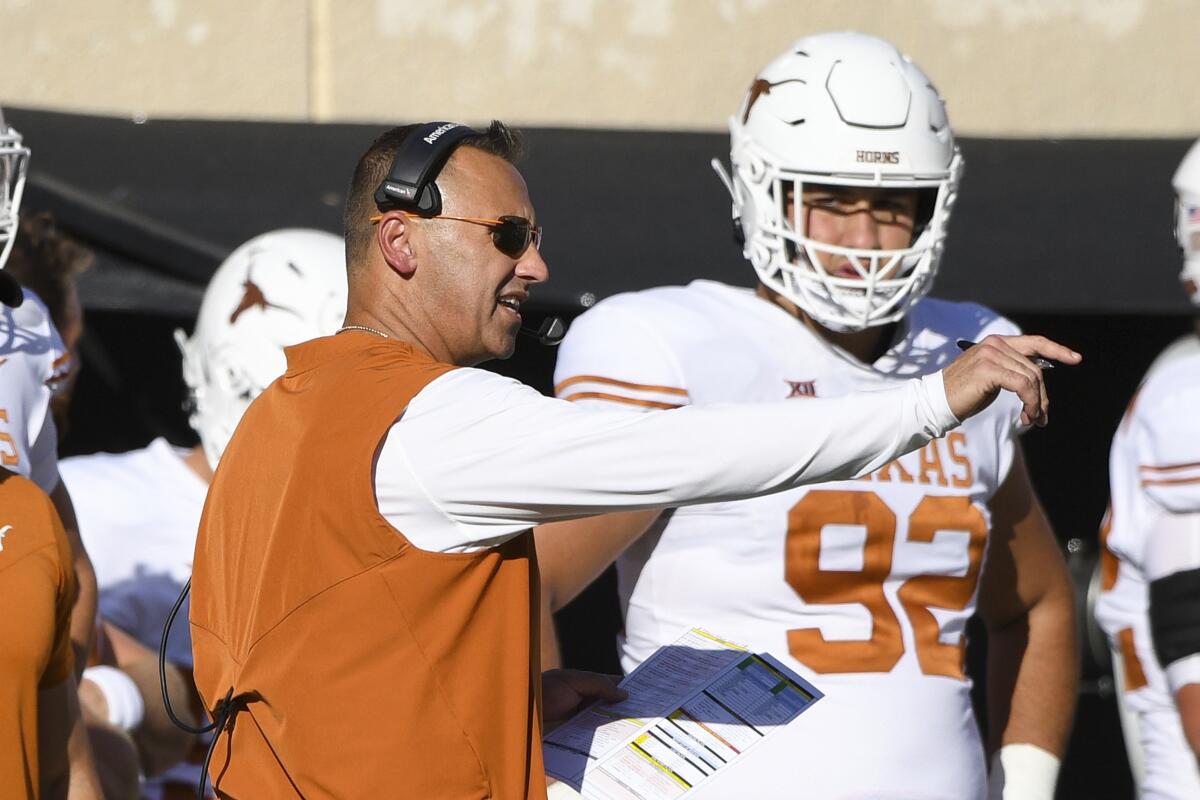 Texas tight end Andrej Karic watches as head coach Steve Sarkisian gestures while speaking on the radio.
