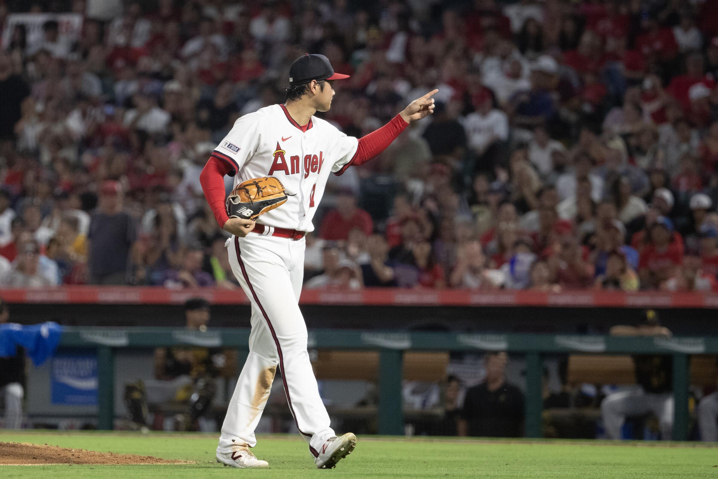 Angels star Shohei Ohtani points to the crowd as he leaves the mound during a game in July.