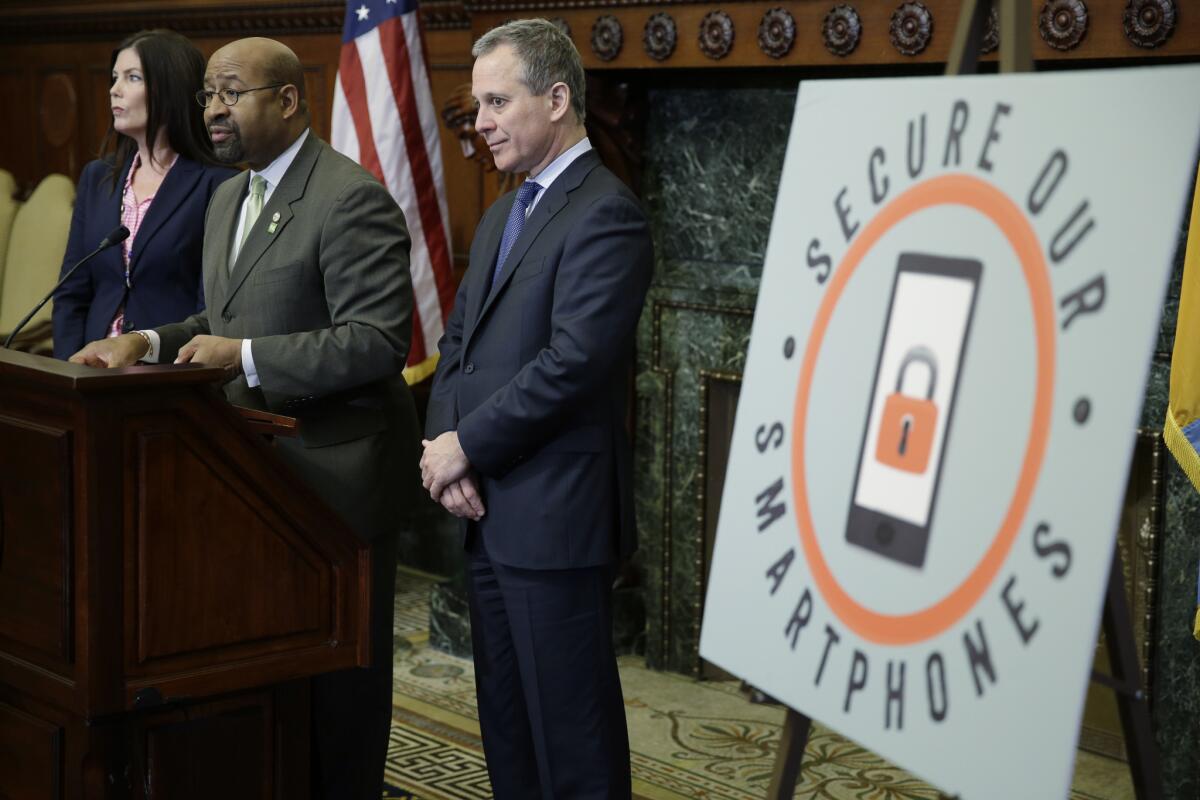 Philadelphia Mayor Michael Nutter speaks as New York Atty. Gen. Eric Schneiderman and Pennsylvania Atty. Gen. Kathleen Kane look on during an October news conference at City Hall in Philadelphia. Schneiderman, Nutter and Kane are joining top prosecutors in San Francisco and New York in a nationwide initiative to thwart smartphone thefts.