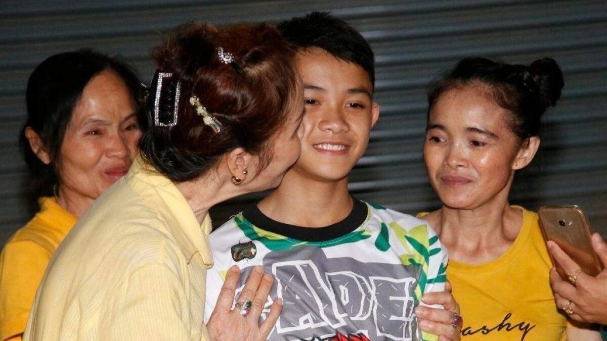 Relatives of Duangphet Promthep, one of the boys rescued from the flooded cave in northern Thailand, greet him as he arrives home in the Mae Sai district of northern Thailand.