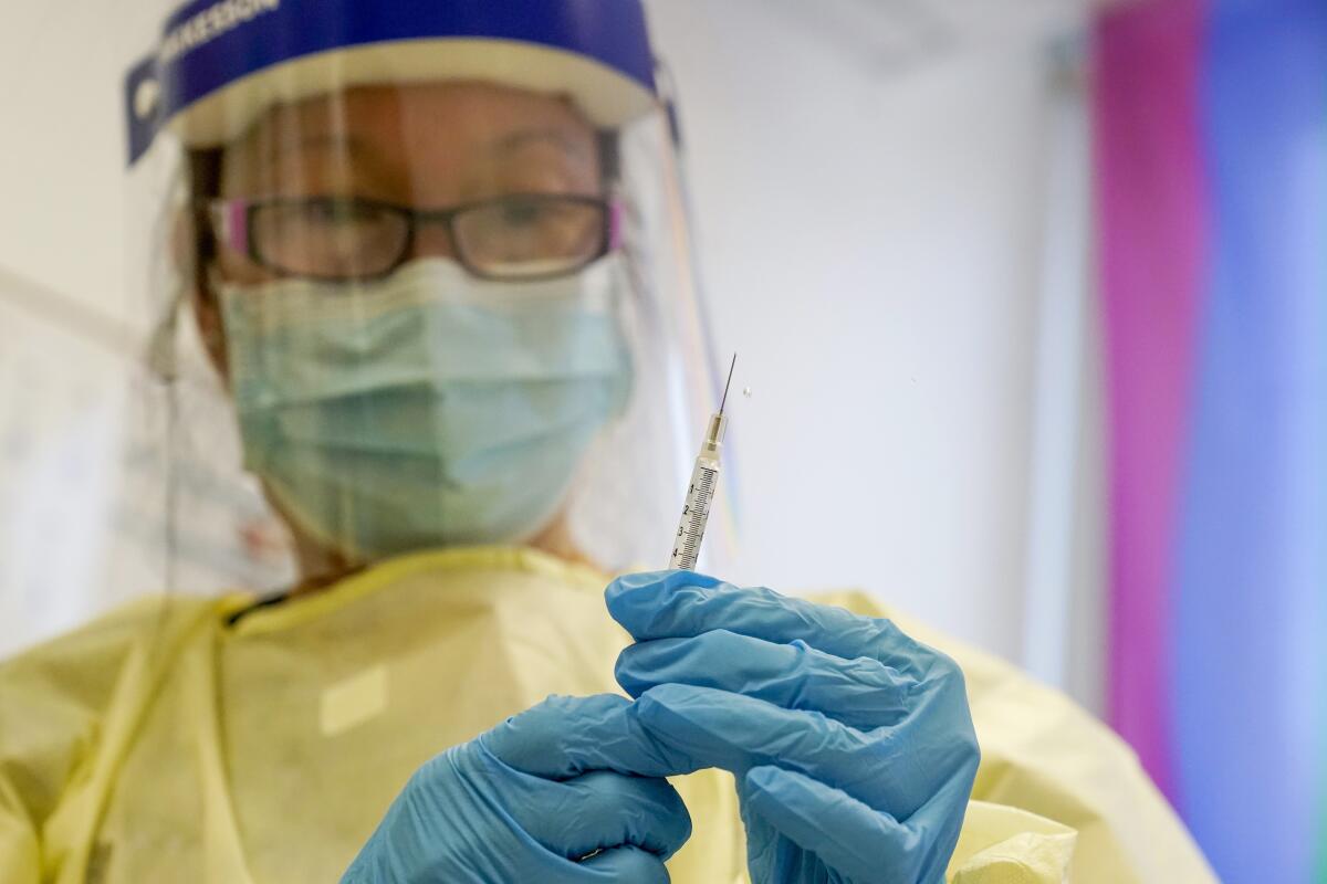 A physician assistant prepares a syringe with the MPX vaccine. 