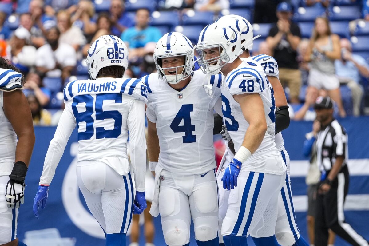 Indianapolis Colts quarterback Sam Ehlinger (4) celebrates after a two-point conversion against the Carolina Panthers during the second half of an NFL football game in Indianapolis, Sunday, Aug. 15, 2021. (AP Photo/AJ Mast)