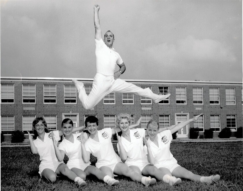 Lawrence "Herkie" Herkimer, who is acknowledged by many as the father of modern cheerleading, does his trademark "Herkie" in the mid-1950s with staff members from the National Cheerleaders Assn.