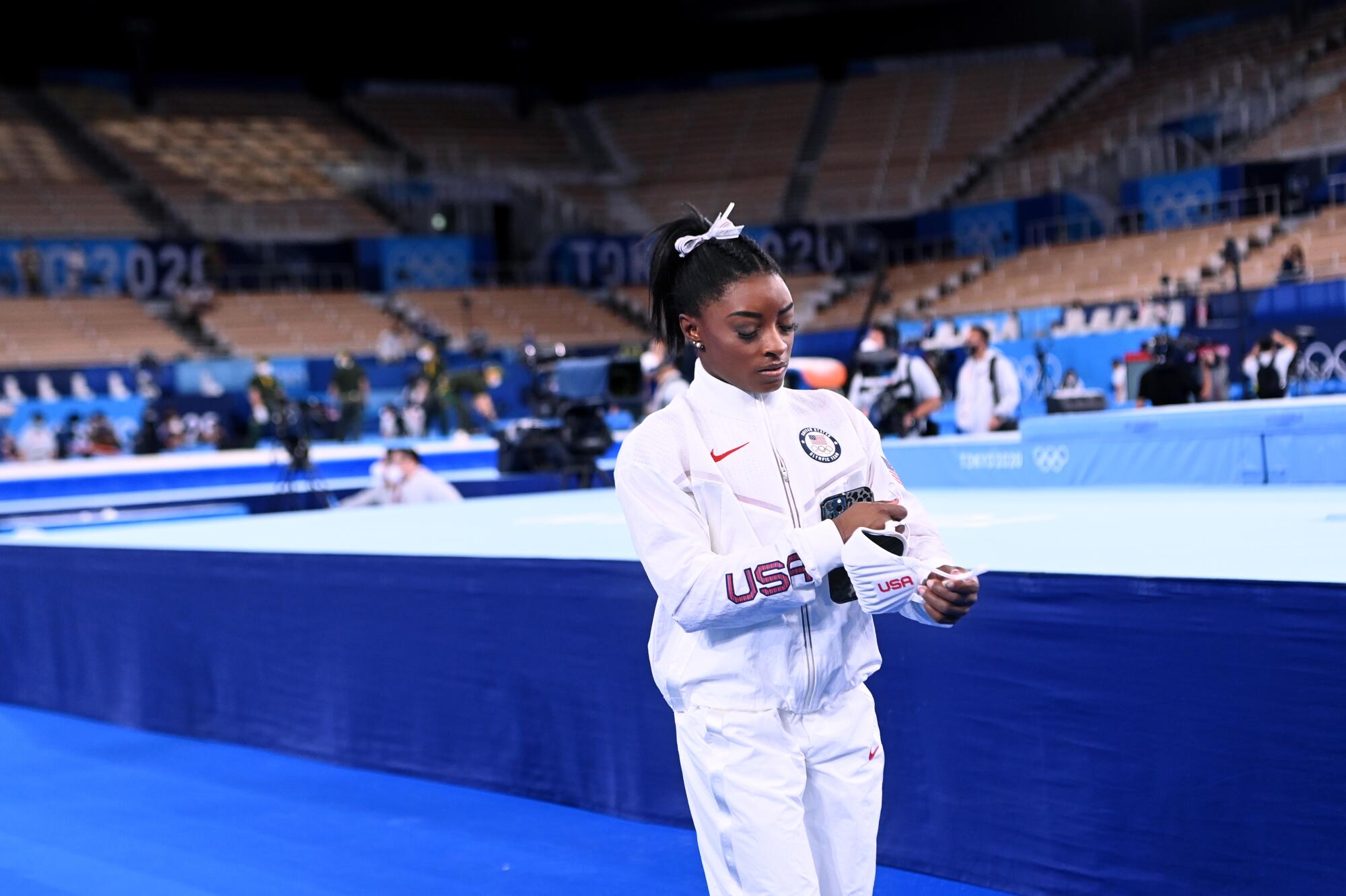 U.S. gymnast Simone Biles walks alone after withdrawing from the women's team final at the Tokyo Olympics in July.