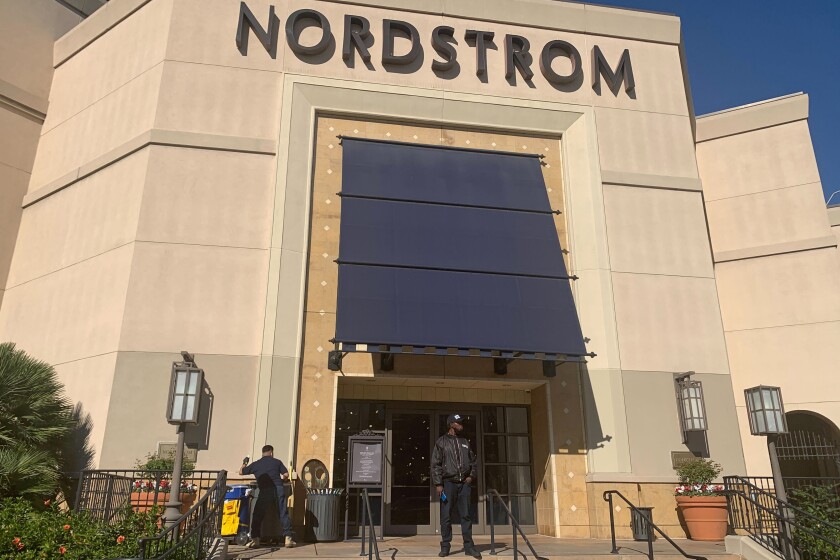 A security guard outside a Nordstrom store.