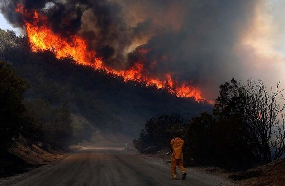 A photographer shoots the Mountain fire on the hills along Apple Canyon Road in Mountain Center.