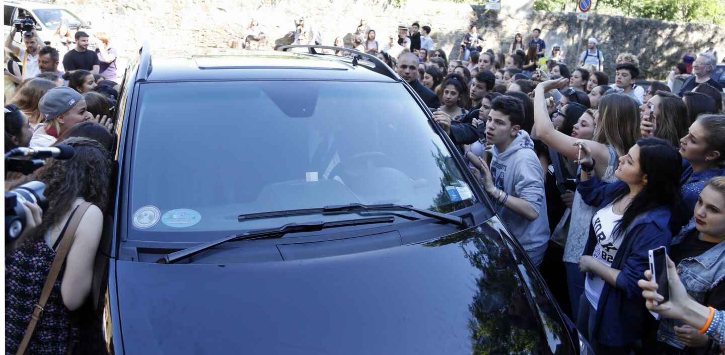 Fans outside Forte di Belvedere in Florence, Italy, trying to see who is in arriving vehicles.