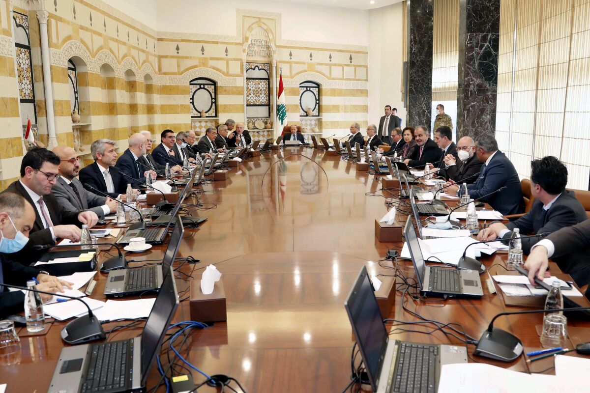 In this photo released by Lebanese government, Lebanese President Michel Aoun, center, leads a cabinet meeting at the presidential palace in Baabda, east of Beirut, Lebanon, Thursday, Feb. 10, 2022. Lebanon's government has approved the state budget for the current year, with a 17% deficit. The prime minister described the development on Thursday as a first step in reforms desperately needed in the crisis-hit country. (Dalati Nohra/Lebanese Official Government via AP)