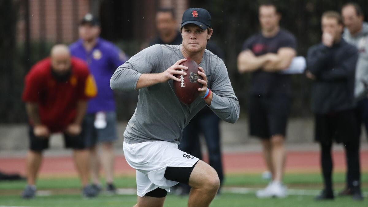 USC quarterback Sam Darnold rolls out as he looks for the receiver during his pro day workout.