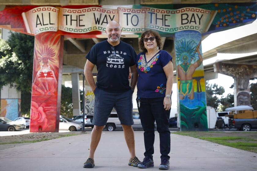 632849-sd-me-oral-stories_NL October 15, 2020 San Diego, CA. Chicano Park Museum co-founder and board chair Josephine Talamantez (right) is photographed with the museum's first artist in residence and playwright Herbert Siguenza at Chicano Park in Barrio Logan. The Chicano Park Museum and Siguenza are collaborating on a year-long project to document the oral histories of Logan Heights and Barrio Logan residents, artists and activists involved in the creation of Chicano Park in 1970. Siguenza plans to collect these oral histories with the help of current residents. The project is funded by the California Arts Council. © 2020 Nancee Lewis / Nancee Lewis Photography
