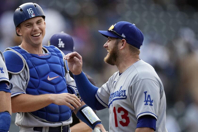 Los Angeles Dodgers catcher Will Smith, left, congratulates first baseman Max Muncy after the 10th inning.