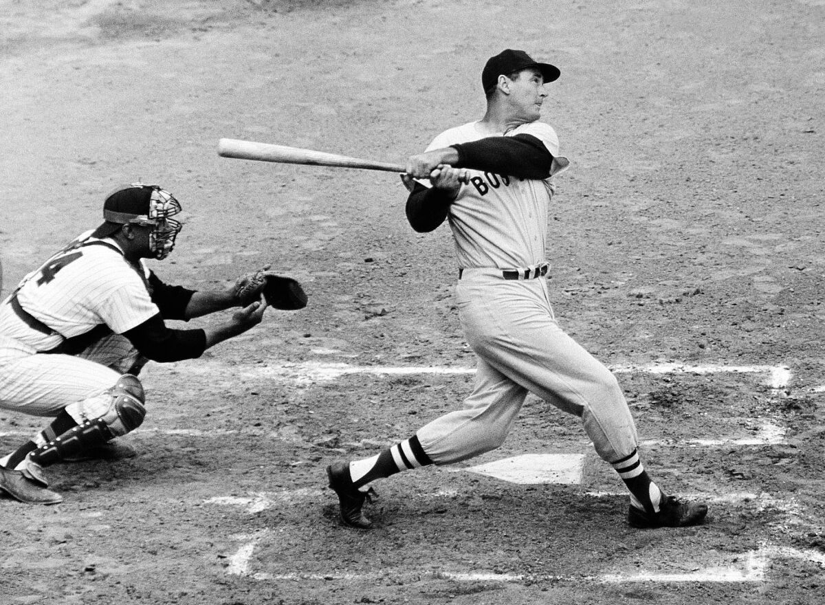 In this April 18, 1960, file photo, Ted Williams of the Boston Red Sox hits a home run against the Senators in Washington.