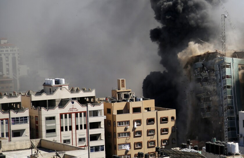CORRECTS DATE TO MAY 15 A view of a 11-story building housing AP office and other media in Gaza City is seen moments after Israeli warplanes demolished it, Saturday, May 15, 2021. The airstrike Saturday came roughly an hour after the Israeli military ordered people to evacuate the building. There was no immediate explanation for why the building was targeted. The building housed The Associated Press, Al-Jazeera and a number of offices and apartments. (AP Photo/Hatem Moussa).