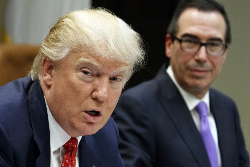 Treasury Secretary Steven Mnuchin listens, right, as President Trump speaks during a meeting on the federal budget at the White House in February 2017.