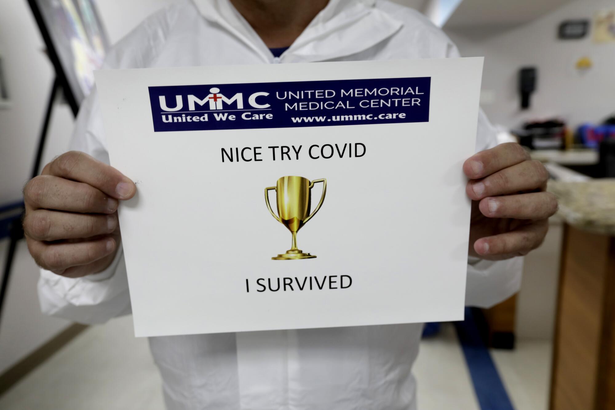 Dr. Joseph Varon gives certificates to COVID-19 survivors as they are discharged. "This is the best experience of my life," he said of fighting the virus, which he likened to a war.