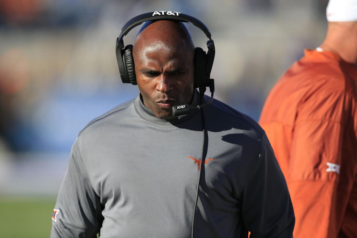 Texas Coach Charlie Strong walks the sideline during the first half of a game against Kansas on Nov. 19.