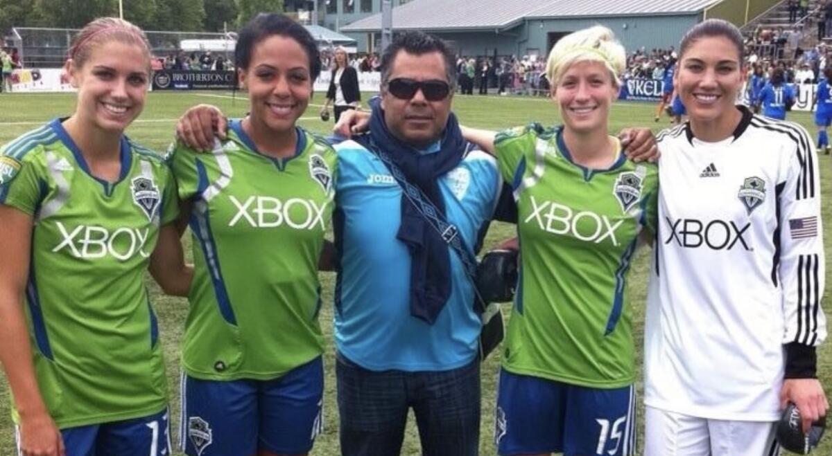 U.S. soccer stars Alex Morgan, left, Sydney Leroux, Megan Rapinoe and Hope Solo pose with Carlos Marroquin.