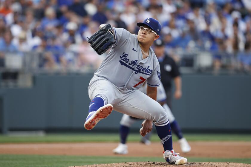 Dodgers pitcher Julio Urias winds up as he delivers a pitch from the mound against Kansas City Royals 