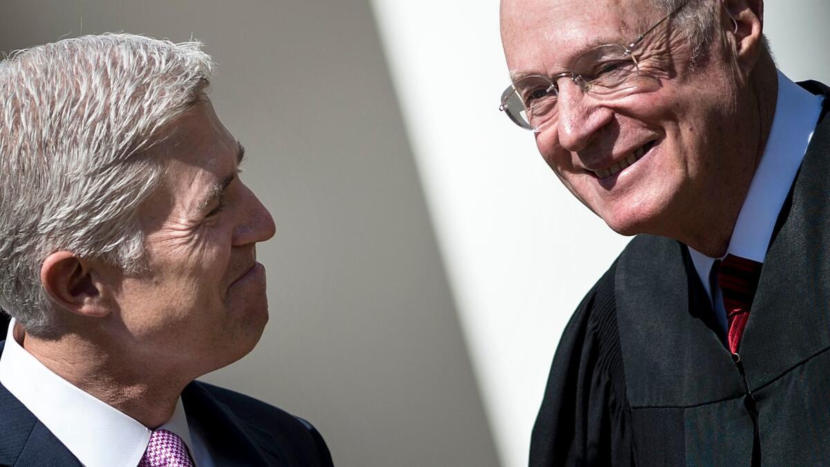 At his swearing-in ceremony last year, Neil Gorsuch, left, President Trump's appointee to the U.S. Supreme Court, smiles with Justice Anthony Kennedy, who recently announced he is retiring.