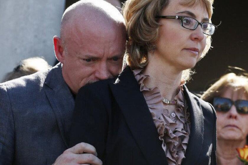Former Rep. Gabrielle Giffords, right, with her husband Mark Kelly at a Tuscon rally in support of expanded background checks on gun control.