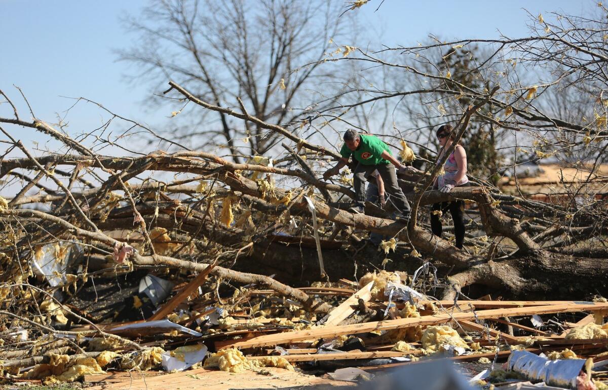 Volunteers help clean up at Calvary Baptist Church after a tornado in Ashland, Miss.