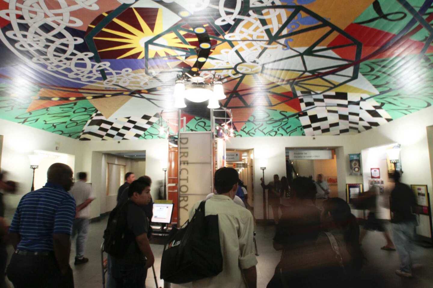 Library patrons walk through the lobby of the Tom Bradley wing.