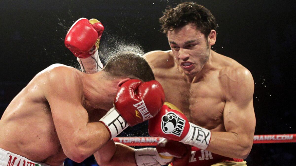 Julio Cesar Chavez Jr., right, connects with a glancing blow to the head Peter Manfredo Jr. during a fight in Houston in November 2011.