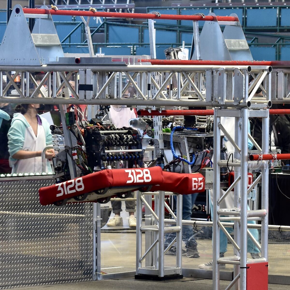 Team 3128 robot hanging from the traversal bar along with alliance partner 6560.