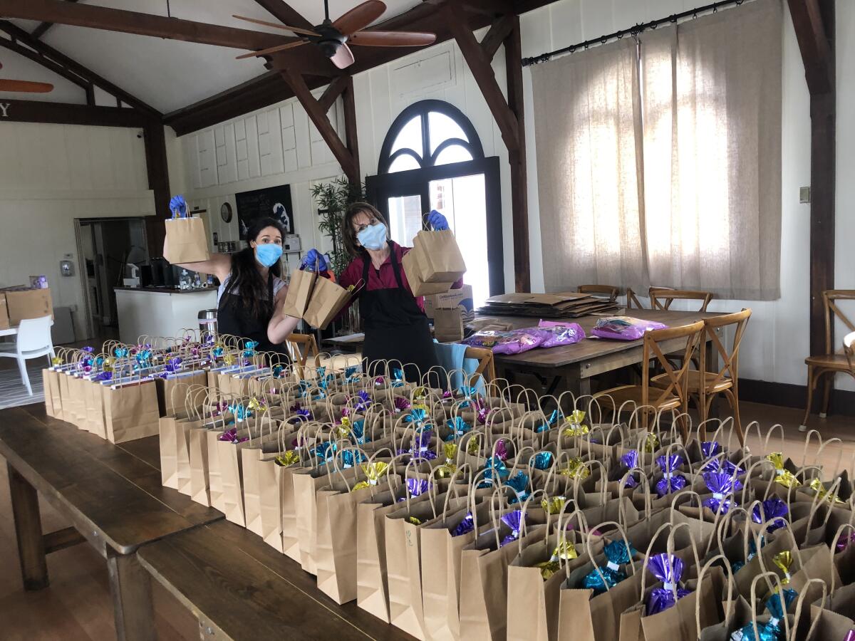 Following current coronavirus safety protocols, church members prepare Easter bags for parishoners.