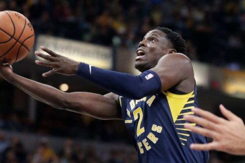 Indiana Pacers guard Darren Collison (2) shoots in front of Utah Jazz guard Ricky Rubio (3) during the first half of an NBA basketball game in Indianapolis, Monday, Nov. 19, 2018. (AP Photo/Michael Conroy)