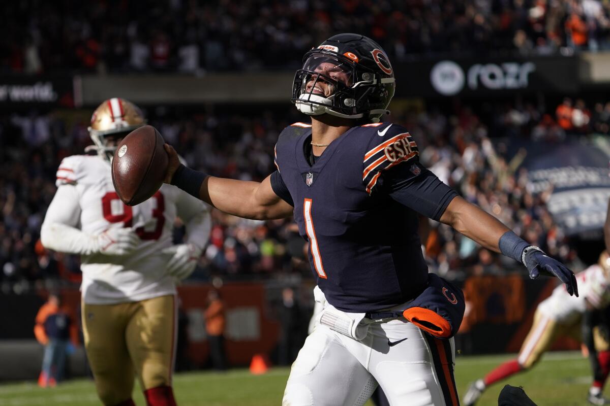 Chicago Bears quarterback Justin Fields begins to celebrate his touchdown against the San Francisco 49ers during the second half of an NFL football game Sunday, Oct. 31, 2021, in Chicago. (AP Photo/David Banks)
