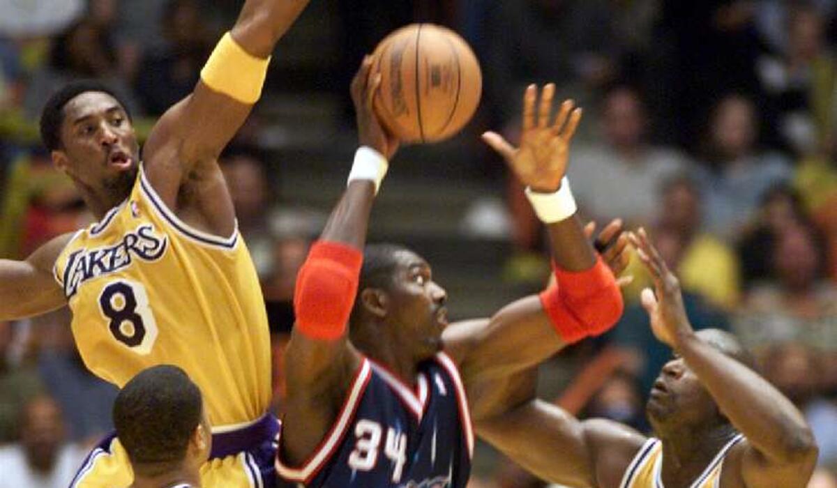 The Lakers' Kobe Bryant and Shaquille O'Neal try to block the shot of Rockets center Hakeem Olajuwon during a 1999 playoff game.