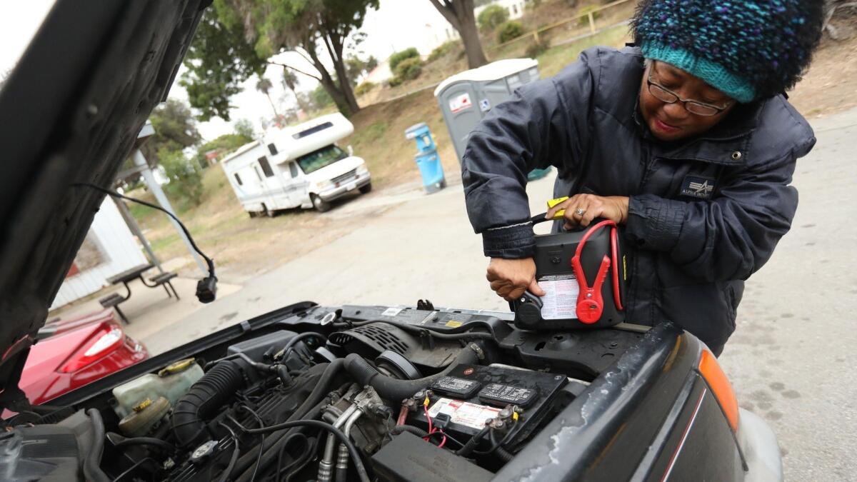 A woman woke up to a dead car battery after spending the night at a Safe Parking L.A. area at the West Los Angeles VA campus on May 31, 2018.