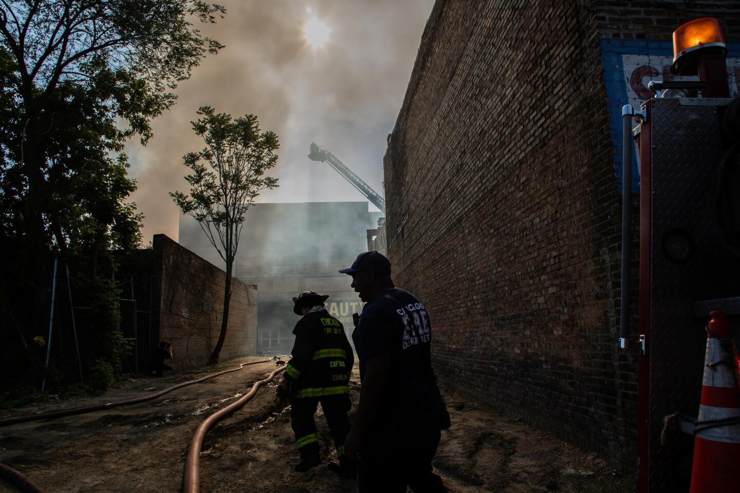 Fire crews battle an extra-alarm fire at the former Gatelys Peoples Store in the city's Roseland neighborhood on Friday morning in Chicago on Friday, June 7, 2019.(Zbigniew Bzdak/Chicago Tribune)