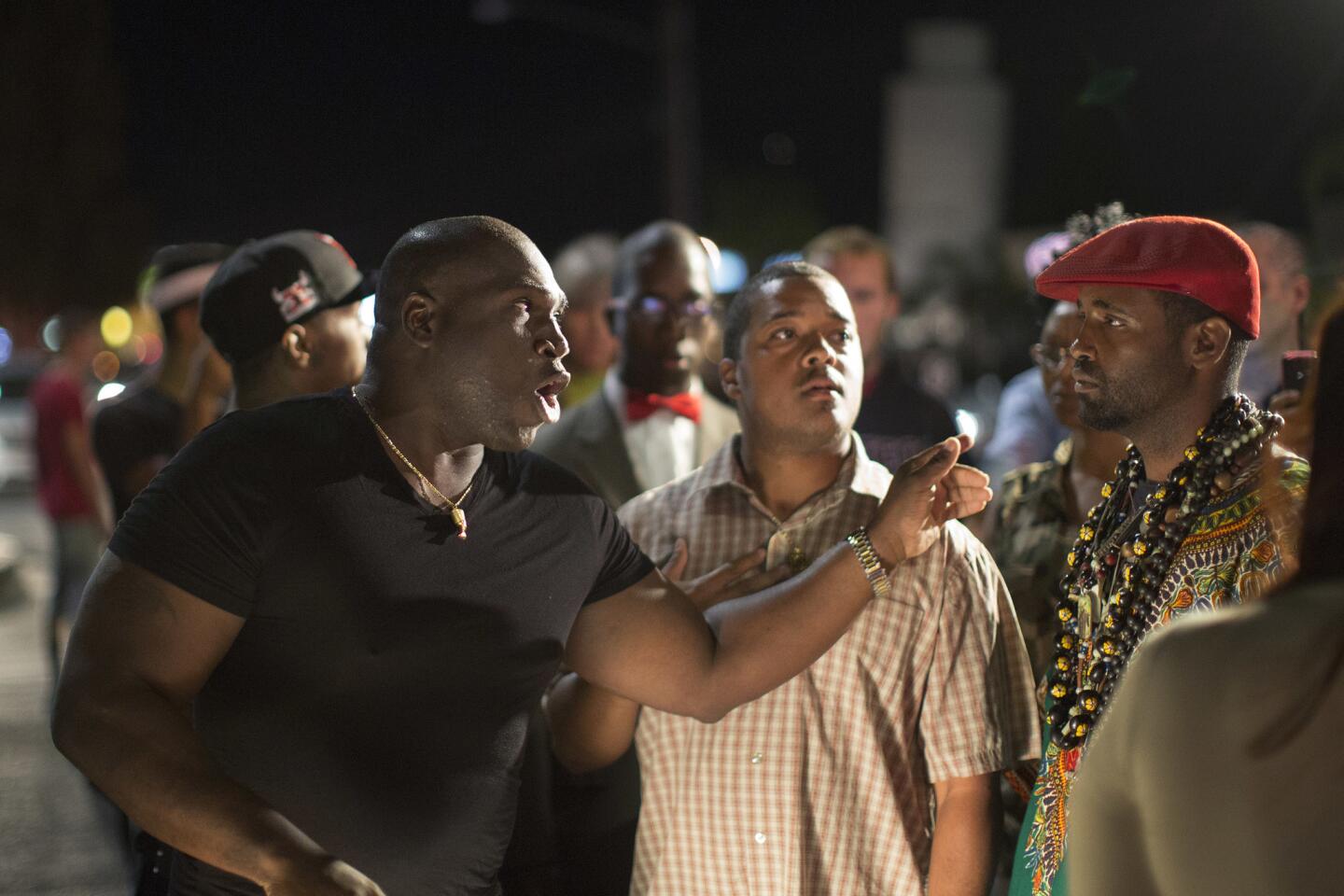 A driver, left, argues with protesters blocking an intersection near the site where Alfred Olango had been shot by police earlier this week in El Cajon.