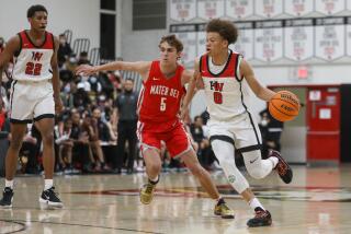 STUDIO CITY, CA - FEBRUARY 11: Harvard-Westlake's Trent Perry drives the ball against Mater Dei boy's basketball team in the Open Division basketball playoffs on Friday, Feb. 11, 2022 in Studio City, CA. (Jason Armond / Los Angeles Times)