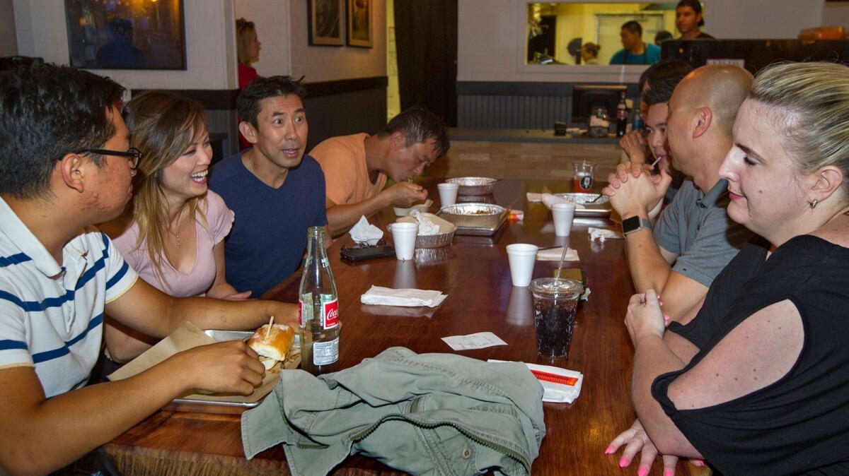 Organizer Stefan Nguyen, third from left, speaks with Viet Taste Buds meetup group members at Nguyen's Kitchen in Costa Mesa.