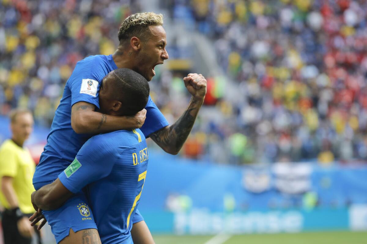 Brazil's Neymar celebrates with teammate Douglas Costa after scoring a goal Friday.