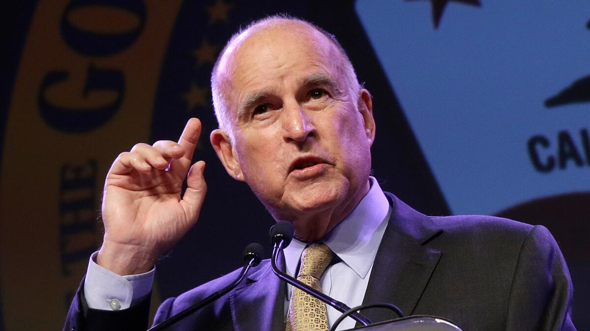 A group of physicians and others has sued to overturn California's aid-in-dying law, which took effect Thursday. The measure was signed by Gov. Jerry Brown, above.