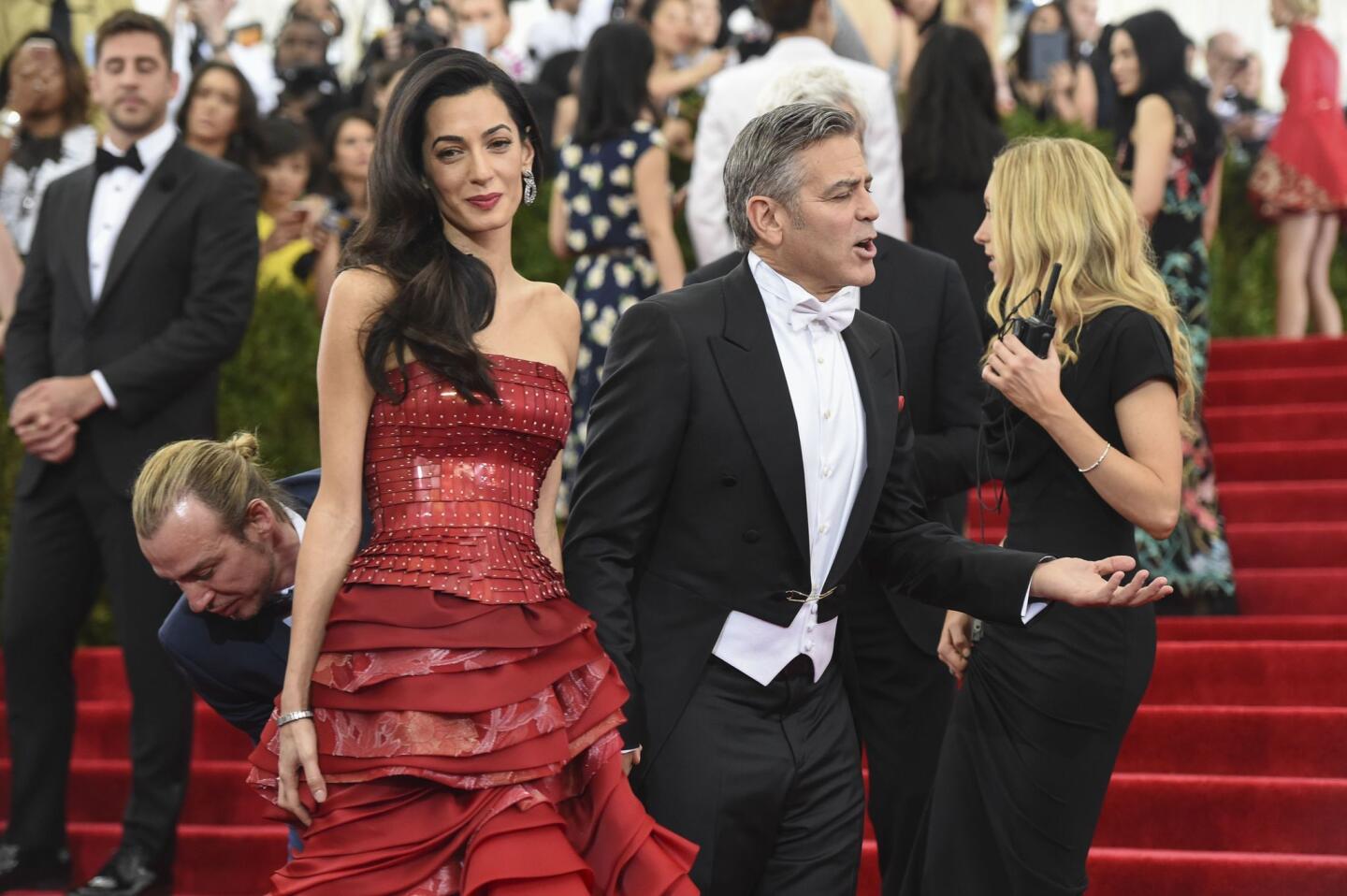 Amal Clooney, in a Maison Margiela gown, with husband George Clooney in a Giorgio Armani Made to Measure formal evening outfit at the "China: Through The Looking Glass" Costume Institute Benefit Gala at Metropolitan Museum of Art on May 4, 2015 in New York City.