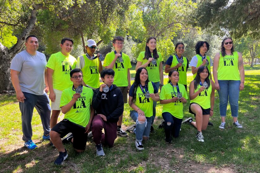 Students Run LA members pose for a photo with their L.A. Marathon medals Saturday.