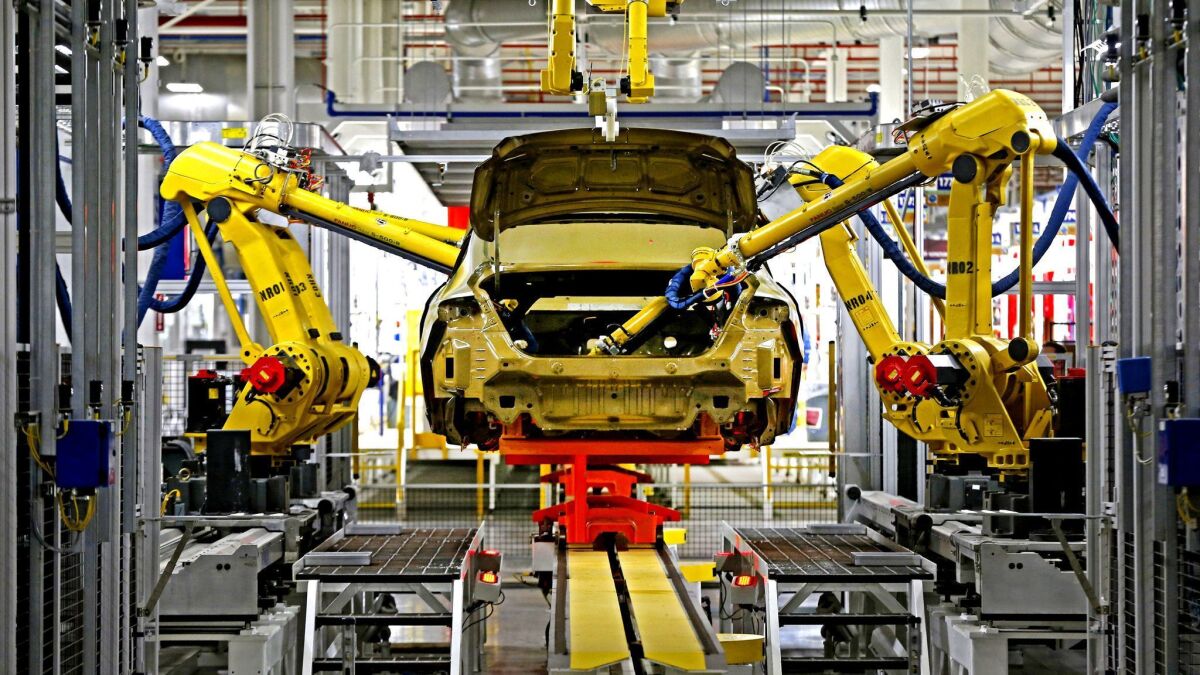 Robots build a Chrysler sedan at the Sterling Heights Assembly Plant in Sterling Heights, Mich.