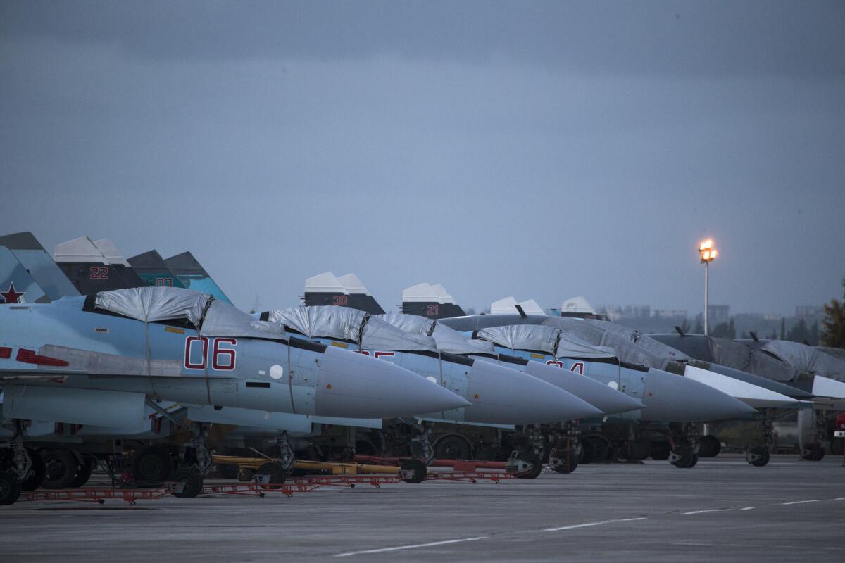 Russian fighter jets and bombers are parked at Hemeimeem air base in Syria.